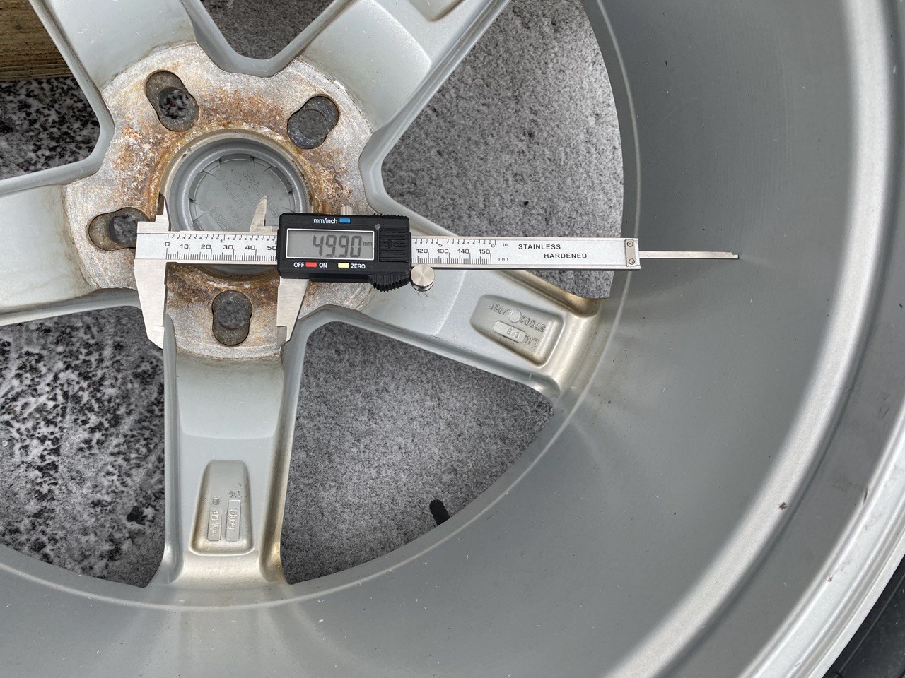 Measuring wheel center bore with calipers